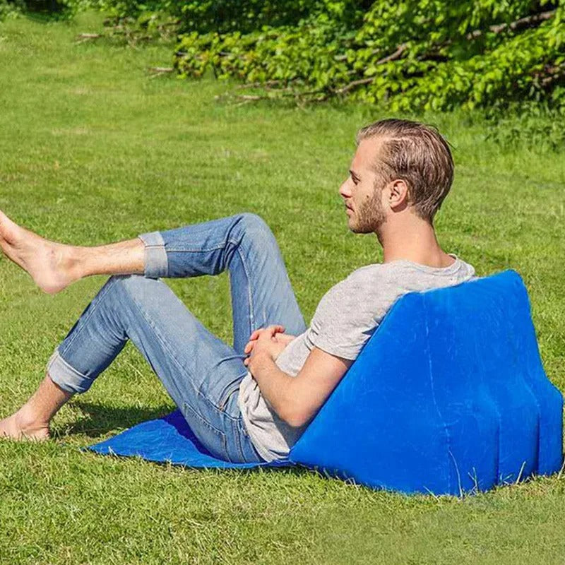 Coussin de plage gonflable et confortable avec une personne dessus poser dans l'herbe