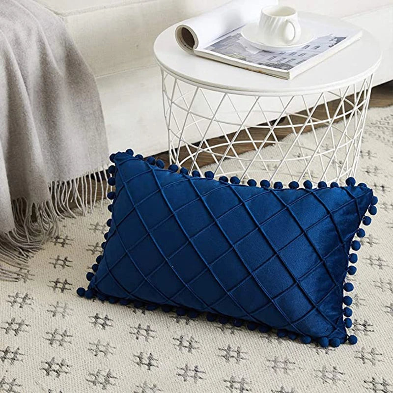 Coussin design bleu de style moderne posé sur un sol beige avec une table blanche derrière