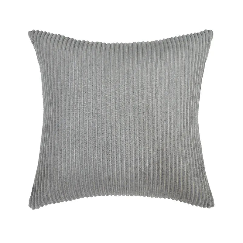 Coussin velours cotelé pour le canapé ici sur un fond blanc.